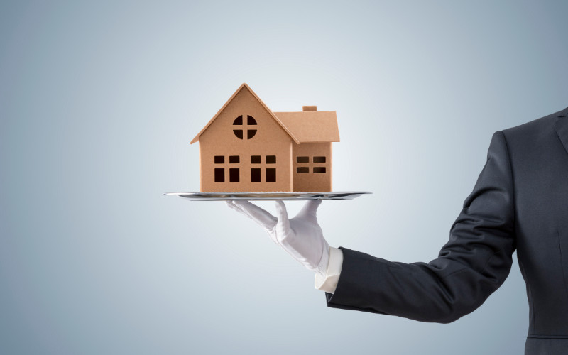 Man holding a small house model